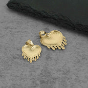 Back view of two 10k gold dripping heart pendants showing hollow reverse setting.