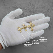 Three gold cross pendants on a gloved hand showing size dimensions.