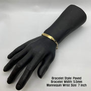 Paved 5.5mm gold Figaro ID bracelet shown on a 7-inch mannequin wrist.