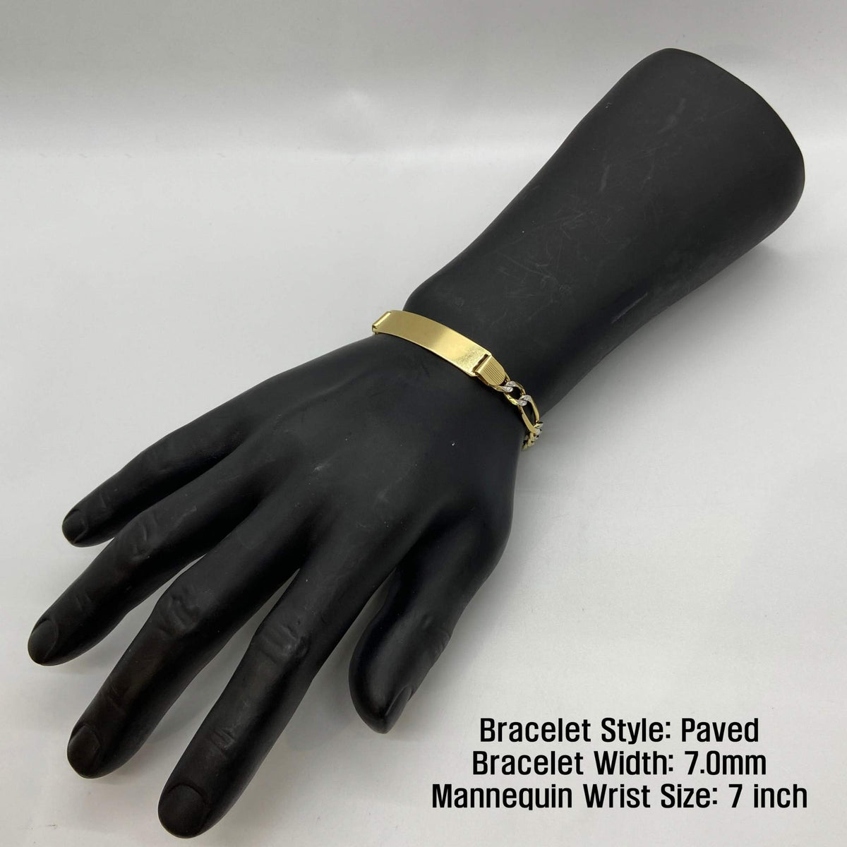 Paved 7.0mm gold Figaro ID bracelet shown on a 7-inch mannequin wrist.