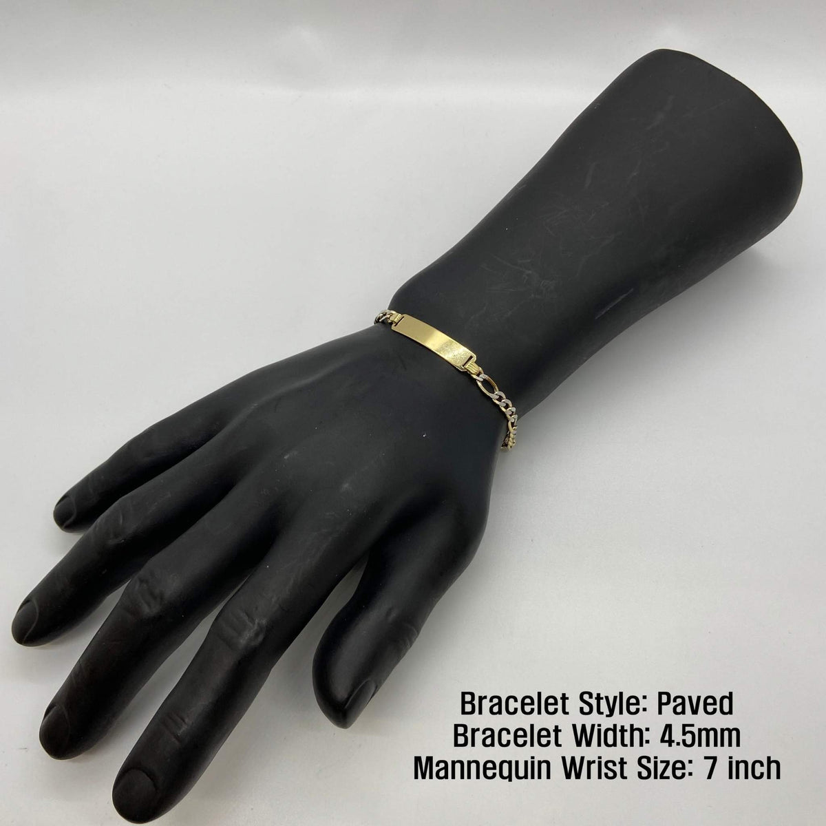 Paved 4.5mm gold Figaro ID bracelet shown on a 7-inch mannequin wrist