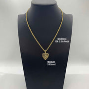 Medium gold filigree heart pendant necklace displayed on black jewelry bust mannequin.