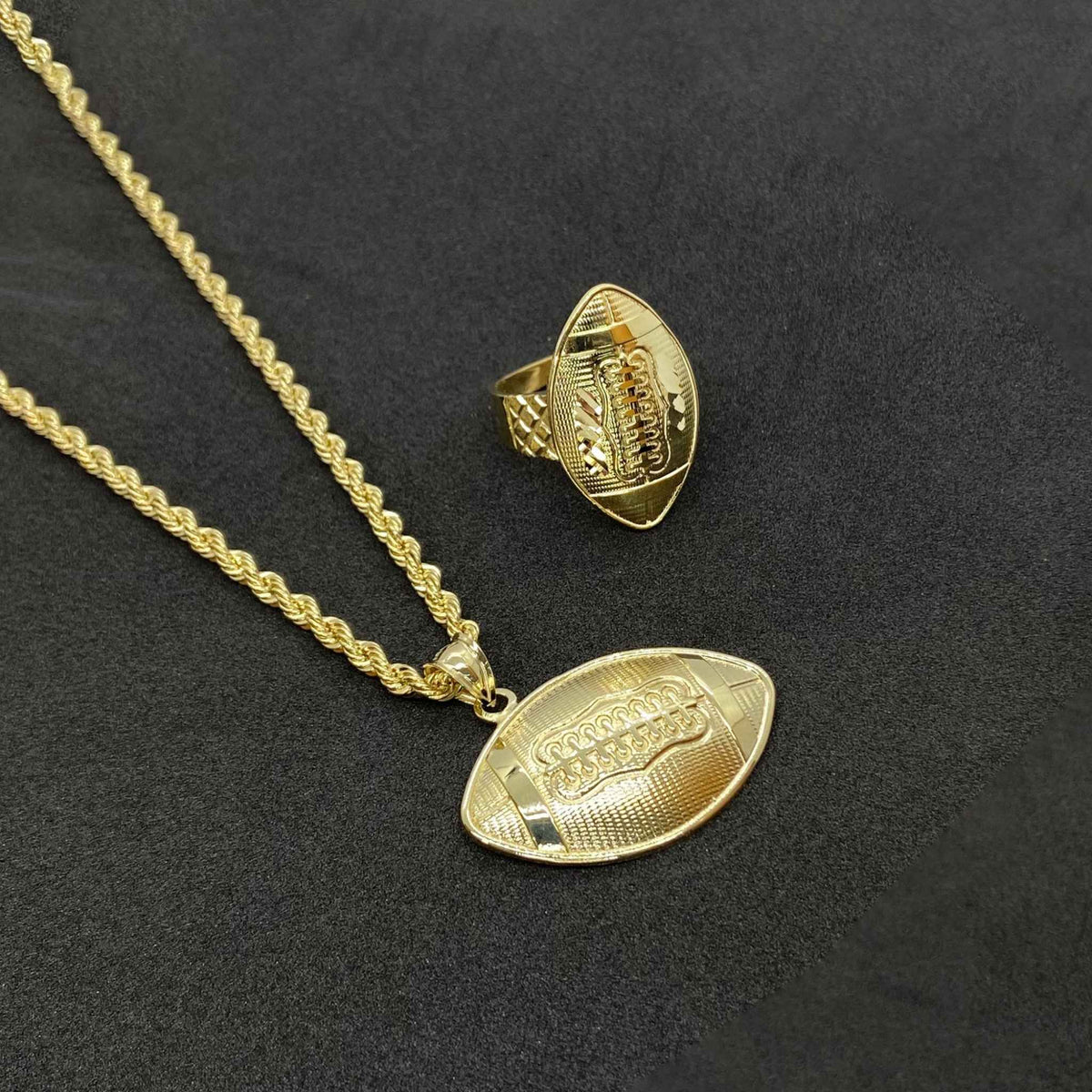 10k yellow gold football pendant necklace paired with a matching gold football ring.