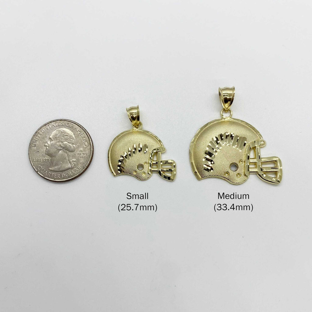 Size comparison of small 25.7mm and medium 33.4mm gold football helmet pendants next to a quarter
