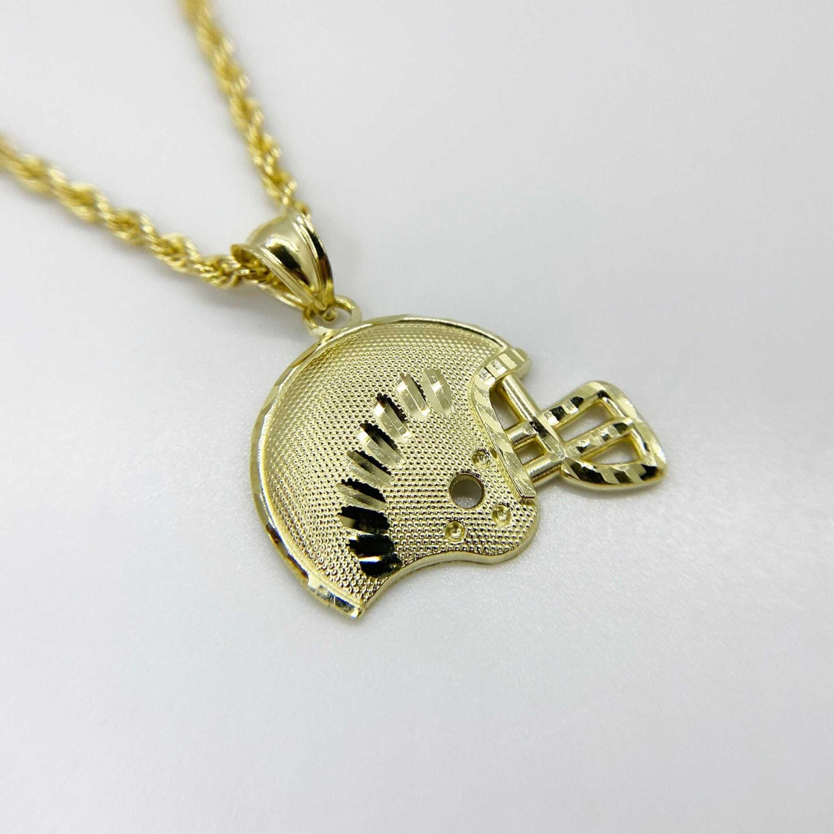 10k yellow gold football helmet pendant with diamond-cut details on a rope chain.