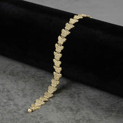 10k gold Forev nugget butterfly link bracelet draped on dark velvet and gray surface