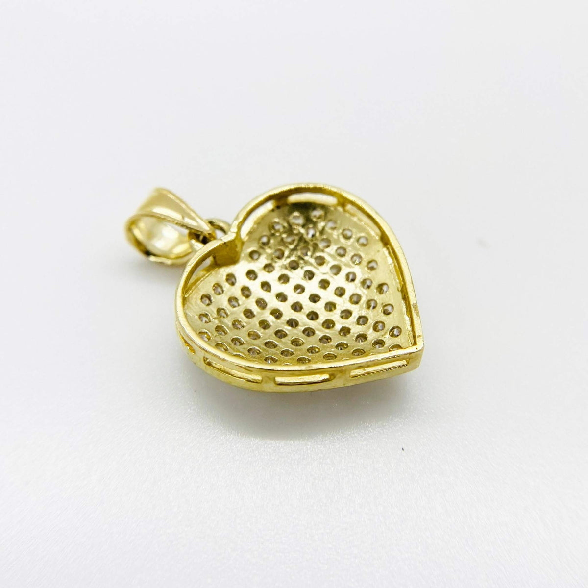 Rear view of an iced-out gold heart pendant charm with hollow back construction.