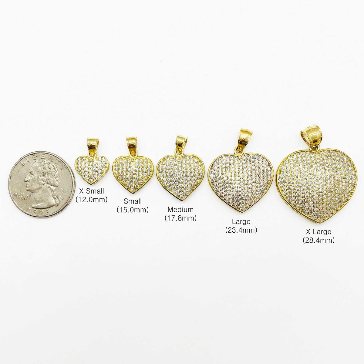 Size comparison of five 10k gold Frida convex heart CZ pendants next to a quarter.