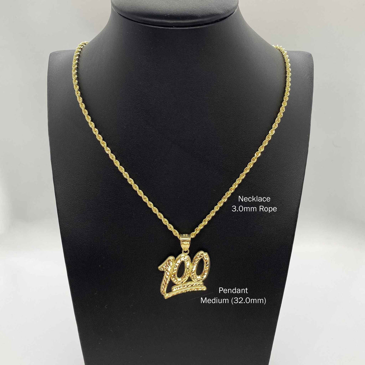 Gold 100 emoji pendant on rope chain displayed on black jewelry mannequin bust.