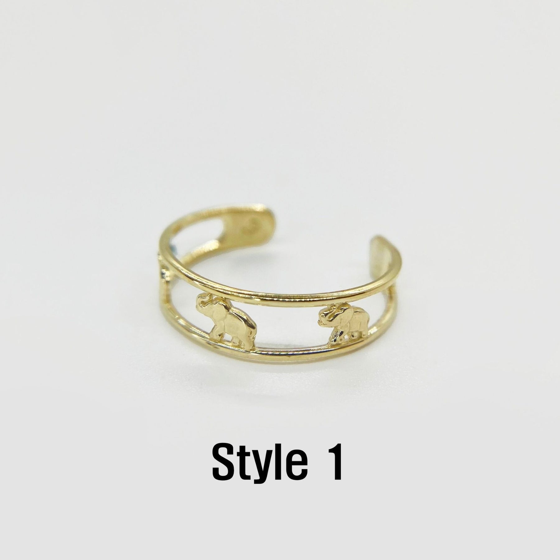 10k Gold toe ring with animal designs on a white background