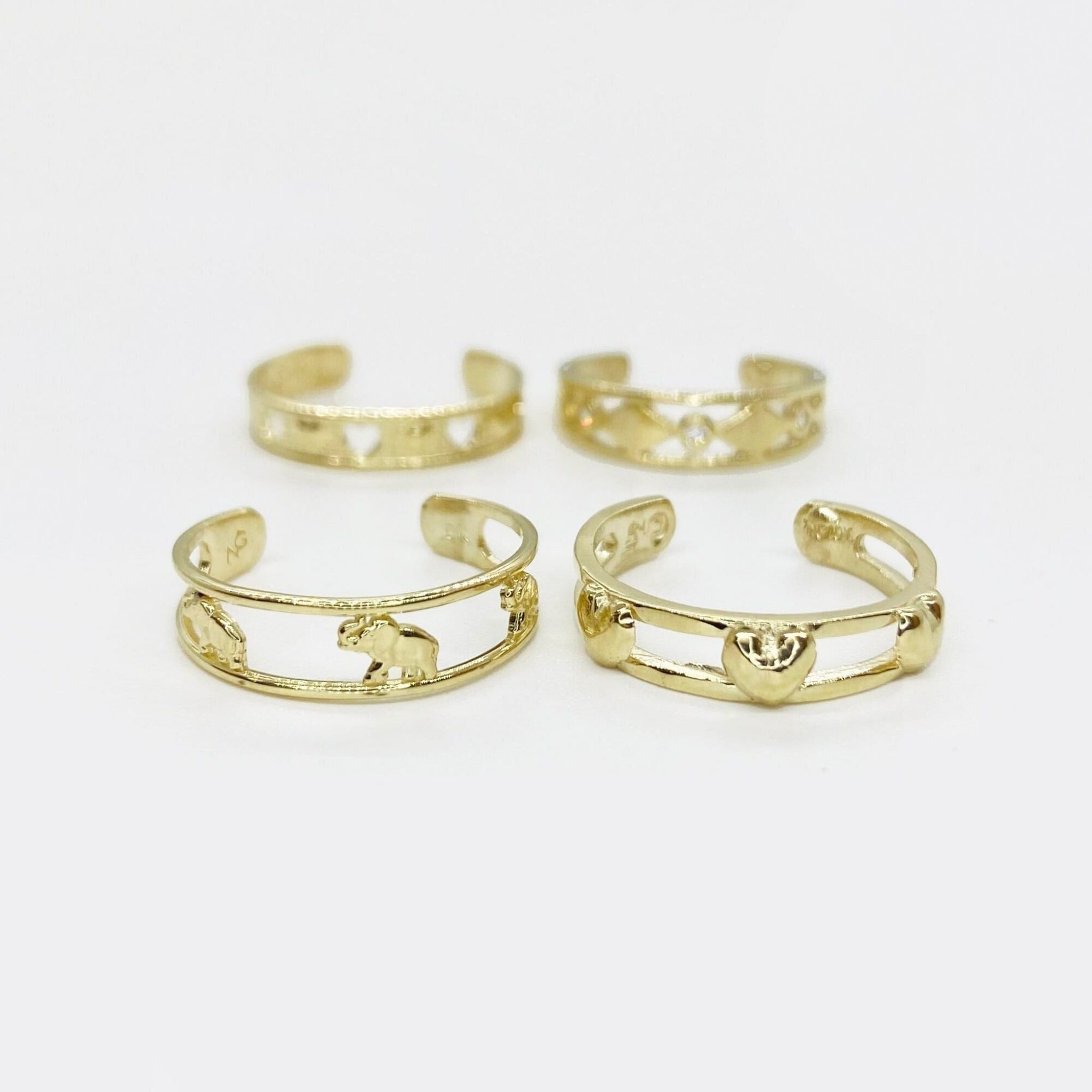 Four 10k gold open-style toe rings on a white background