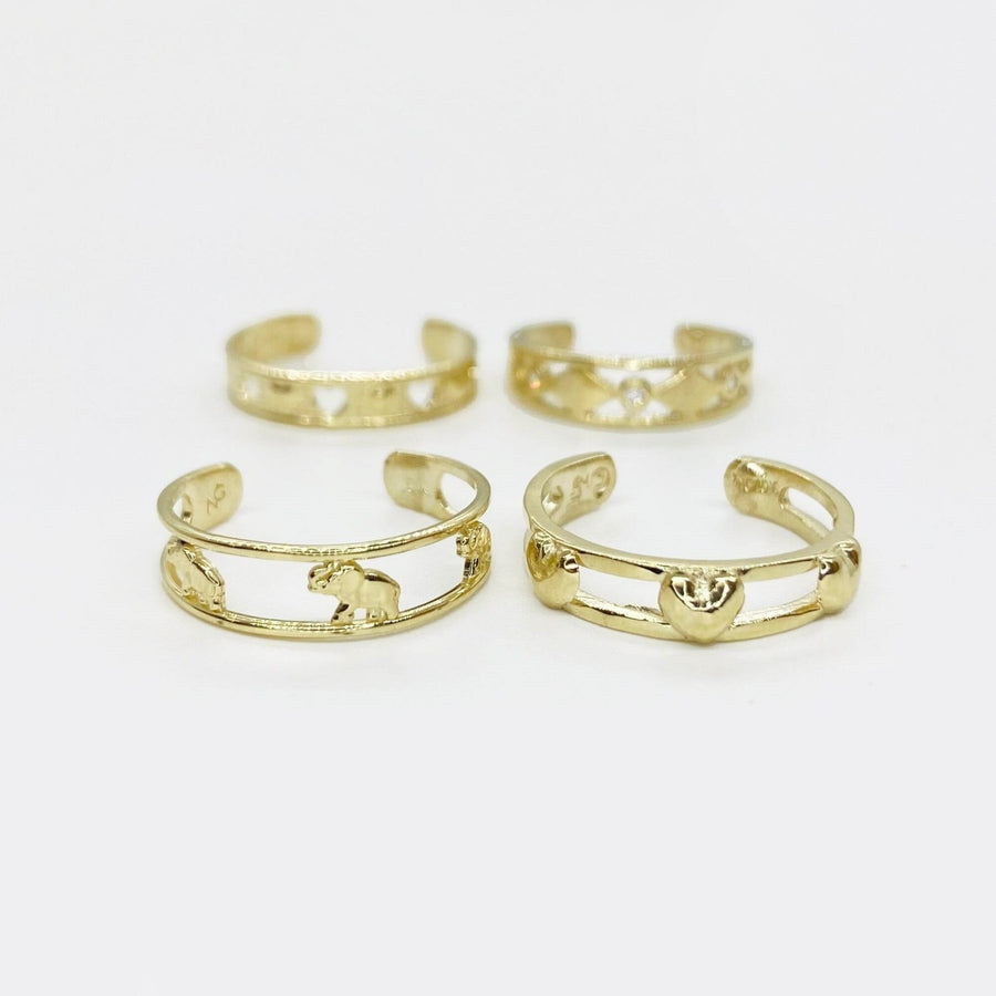 Four 10k gold open-style toe rings on a white background