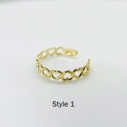 10k Gold Toe Ring with interlocking heart designs on a white background