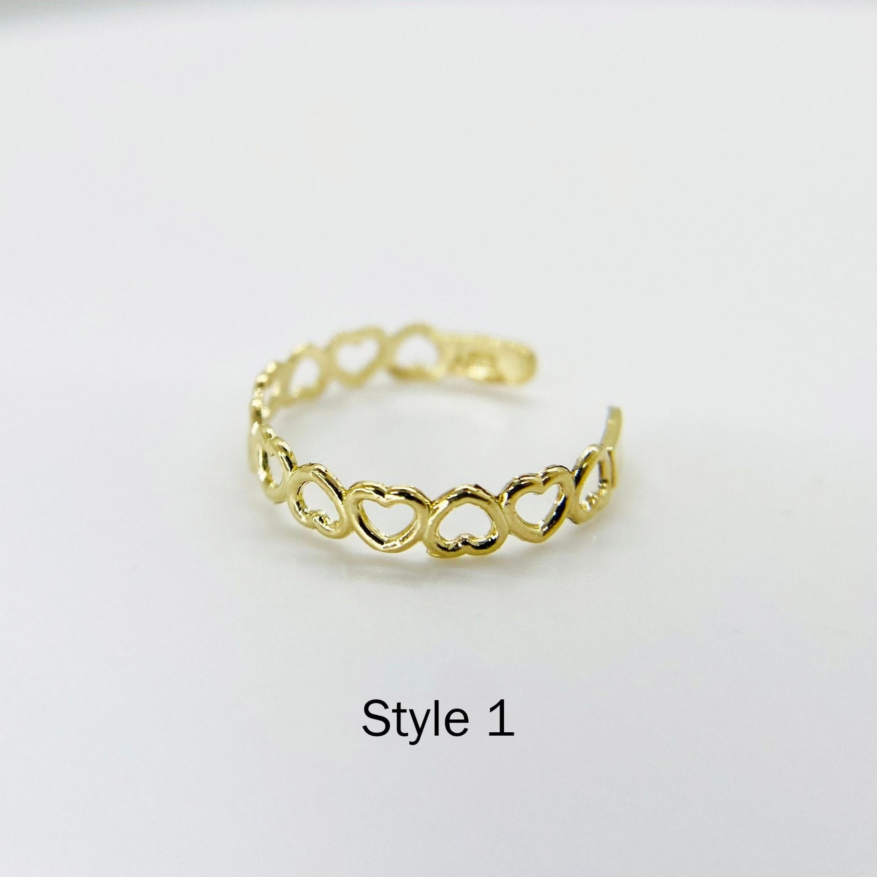 10k Gold Toe Ring with interlocking heart designs on a white background