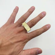 Hand wearing a 10k gold ring with a Hundred Dollar Bill design.