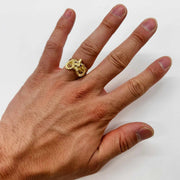Hand wearing a 14k gold ring with Bighorn Sheep Red Eye design 