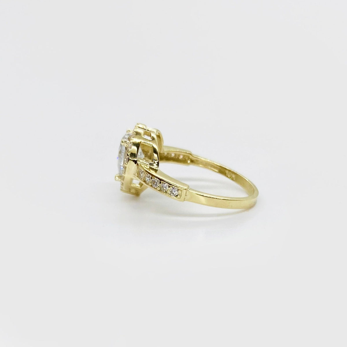 10k Gold ring with cubic zirconia accents side view on a light gray background