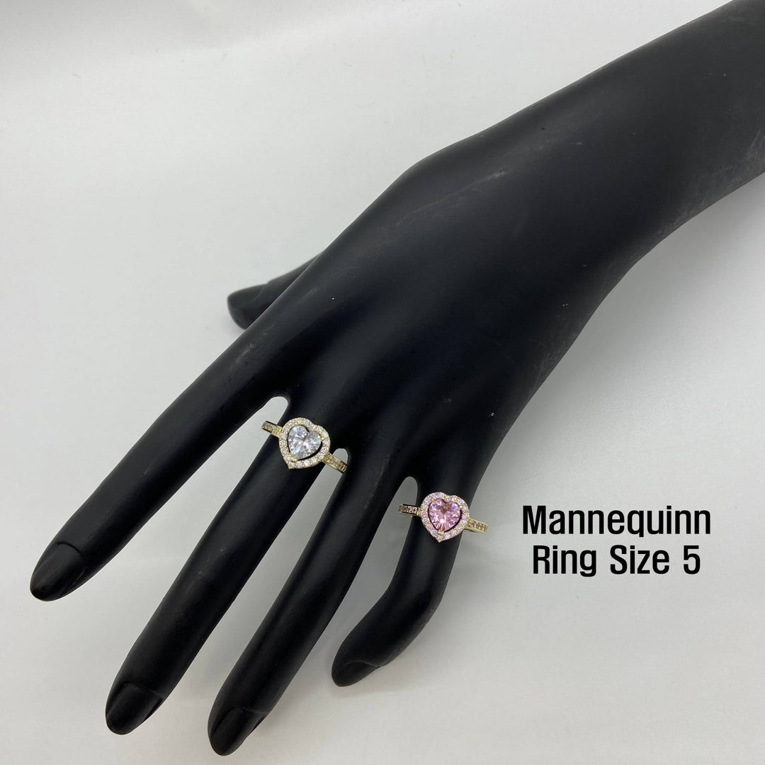 Two 10k gold rings with heart design displayed on a black mannequin hand with text indicating ring size 5. 