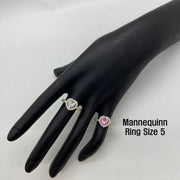 Two 10k gold rings with heart design displayed on a black mannequin hand with text indicating ring size 5. 