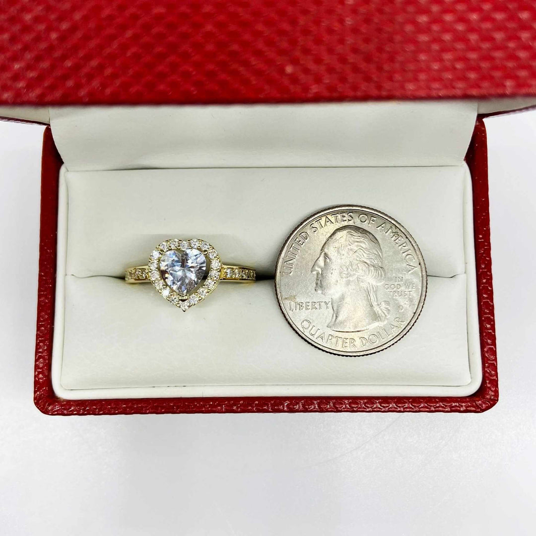 Heart shaped 10k gold ring in a red box with a quarter for scale.