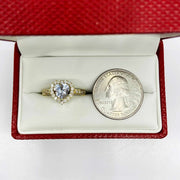 Heart shaped 10k gold ring in a red box with a quarter for scale.