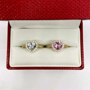 Two 10k gold rings with color pink and white heart shape cubic zirconia design in a red jewelry box 