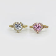 Two 10k heart-shaped rings with color pink and white cubic zirconia on a white background