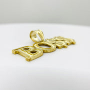 Angled low-profile view of a 10k yellow gold "BOSS" word charm pendant.