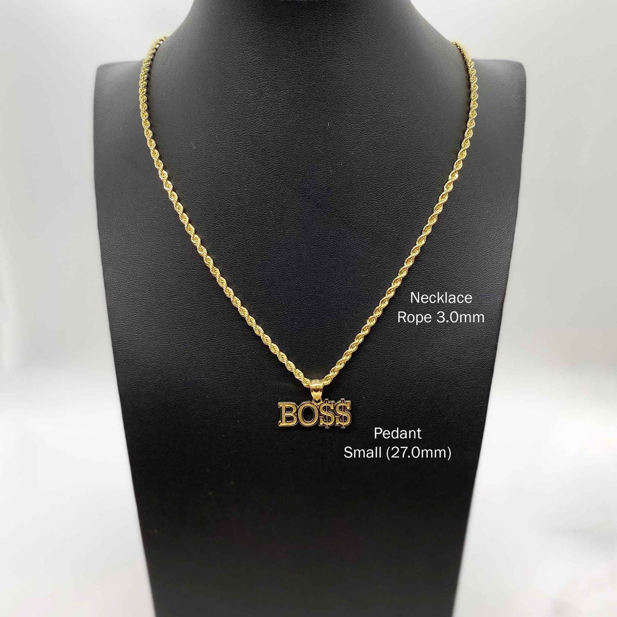 Small 27.0mm 10k gold "BOSS" pendant necklace displayed on a black jewelry bust.