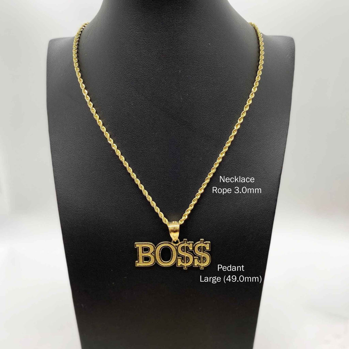 Large 49.0mm 10k gold "BOSS" pendant necklace displayed on a black jewelry bust.