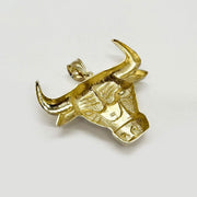 Back view of a 10k yellow gold bull head pendant showing textured underside detailing.