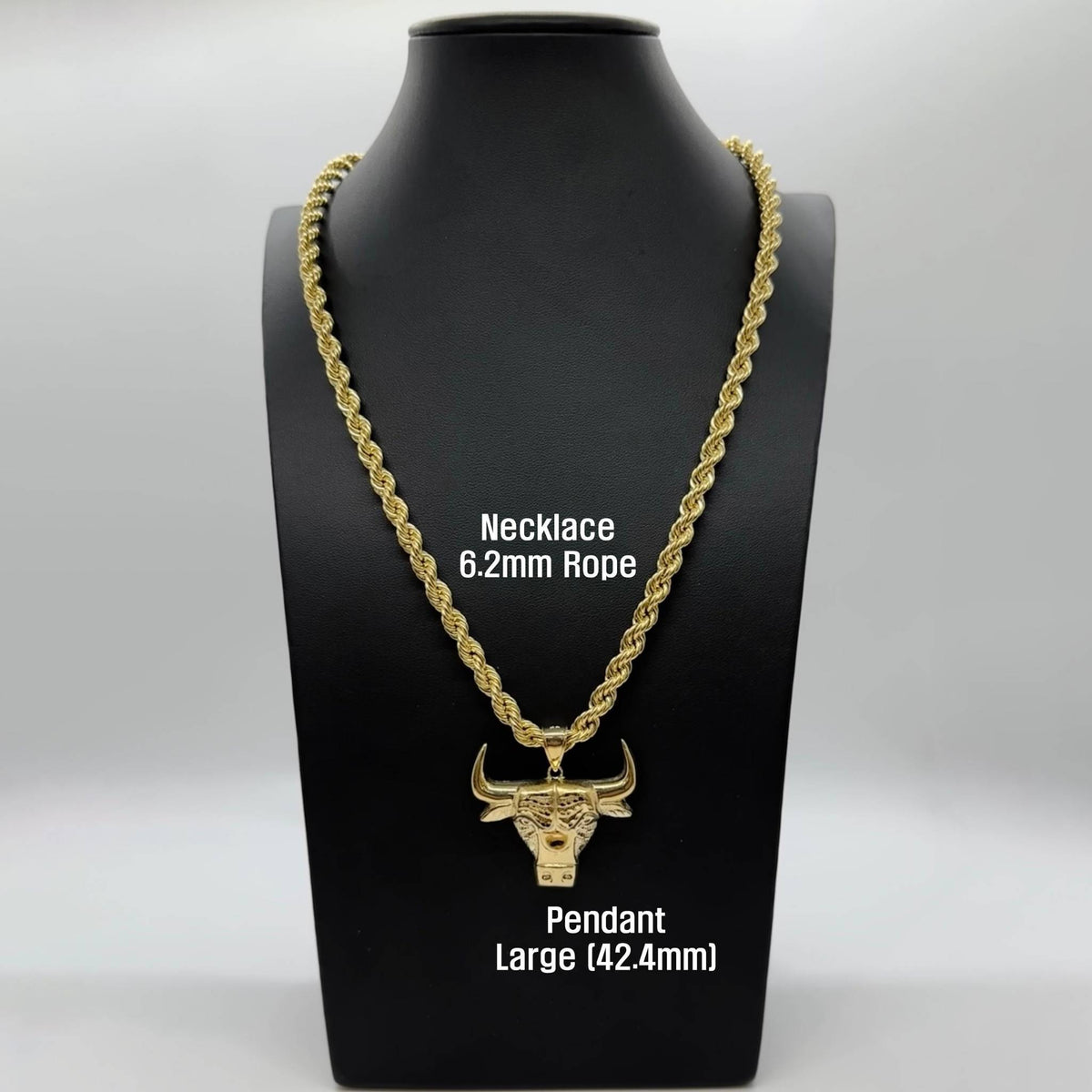Large gold bull head pendant on a 6.2mm rope chain displayed on mannequin.