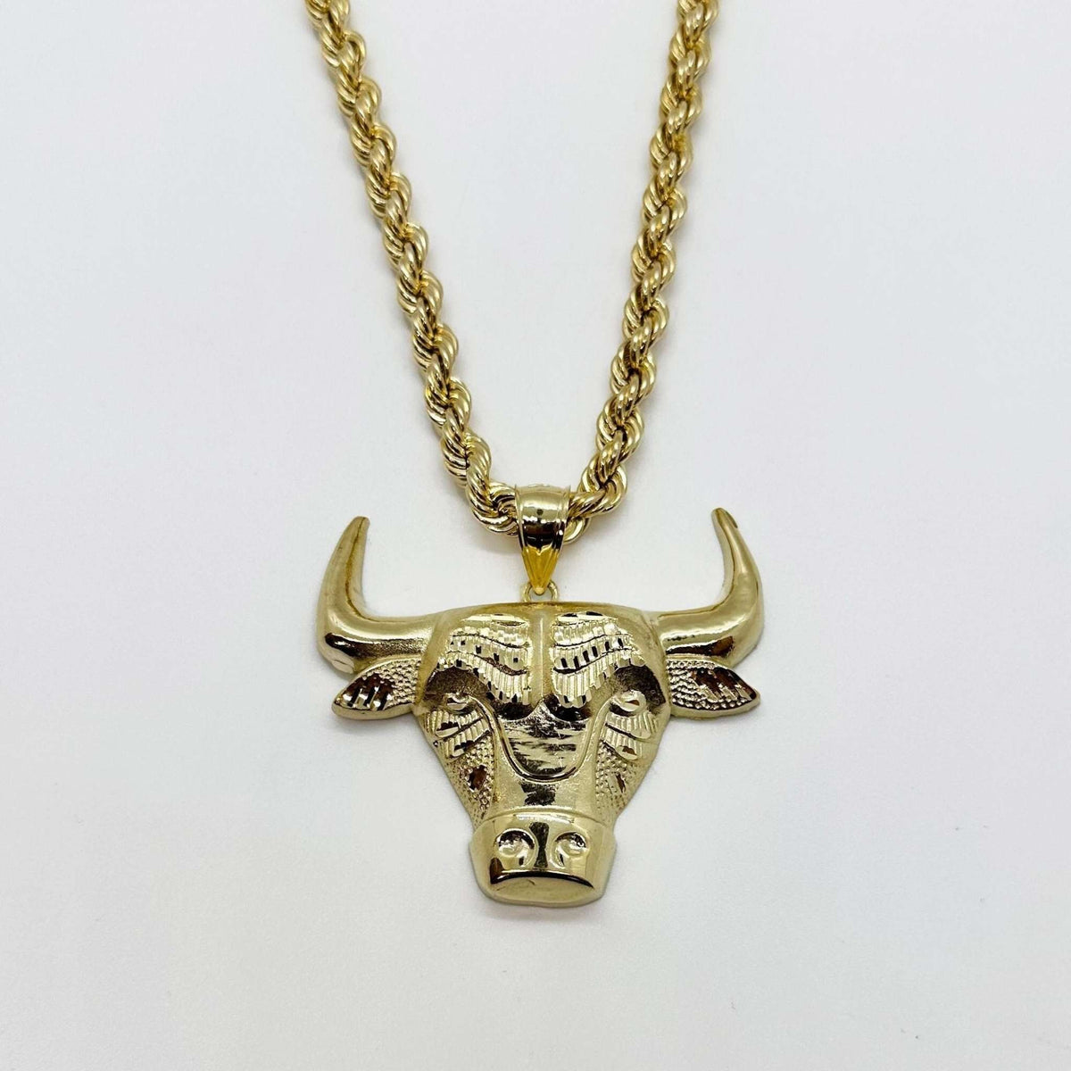 10k solid gold bull Taurus head pendant displayed on a matching gold rope chain.