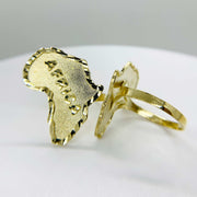 14k Gold ring with africa map shaped design on a light gray background