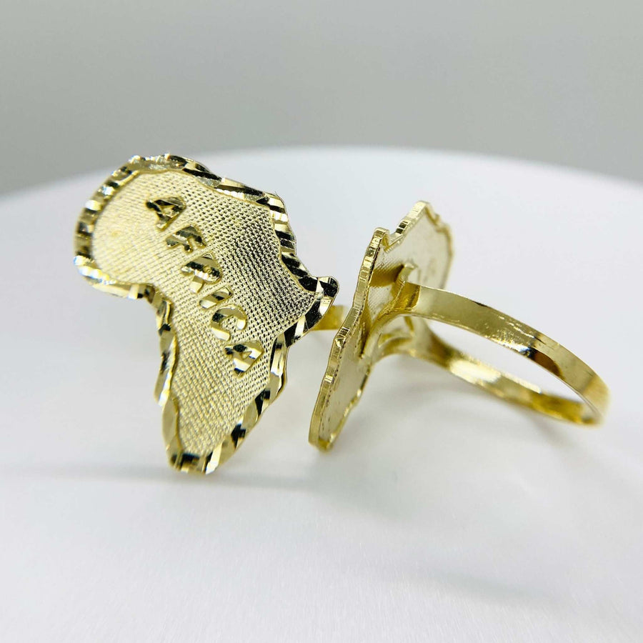 14k Gold ring with africa map shaped design on a light gray background