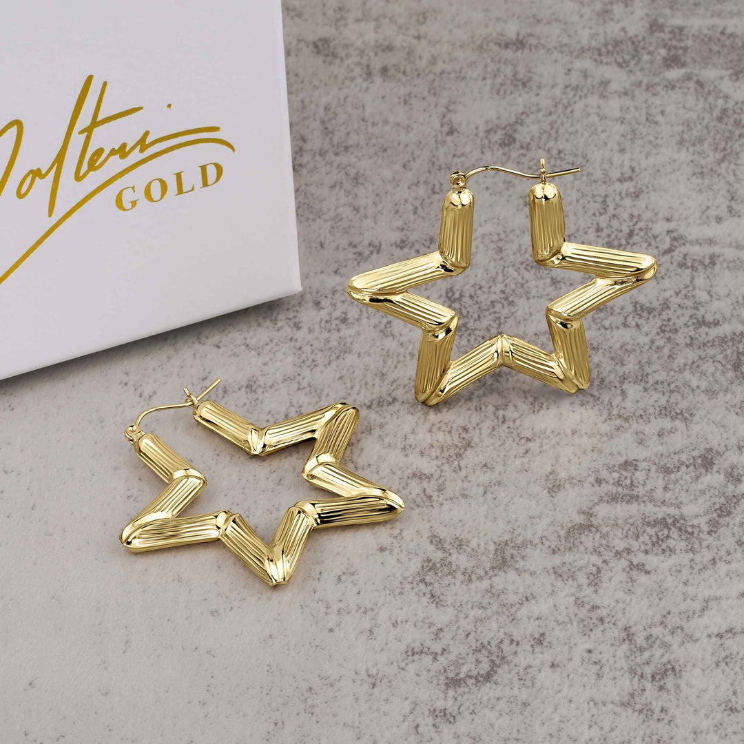 Pair of 10k yellow gold star-shaped bamboo hoop earrings with a high-polish finish.