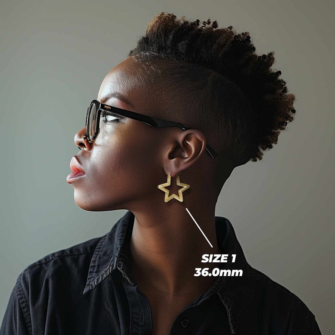 Profile view of a model wearing 36mm 10k gold star-shaped bamboo hoop earrings.