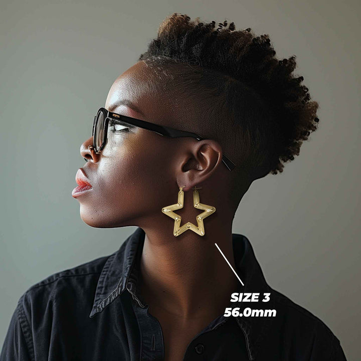 Profile view of a model wearing 46mm 10k gold star-shaped bamboo hoop earrings.