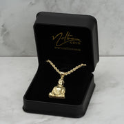 A 10k gold Buddha pendant and rope chain inside an open branded black jewelry box.