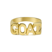 10k yellow gold ring with block letters spelling GOAT on white background.