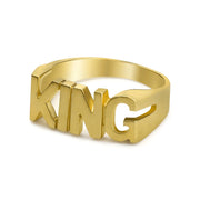 Angled view of a 10k gold KING block letter ring on white background.