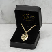 10k yellow gold lion pendant and chain displayed inside a branded black jewelry box.