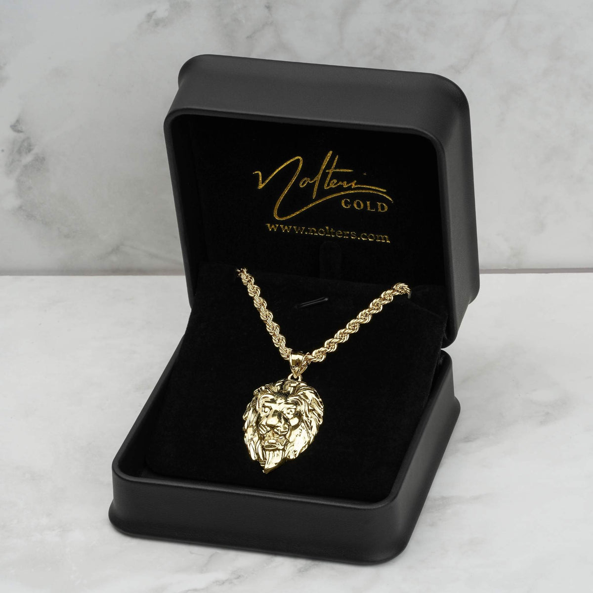 10k yellow gold lion pendant and chain displayed inside a branded black jewelry box.