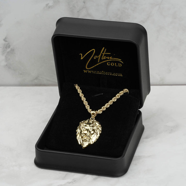 10k yellow gold lion pendant and chain displayed inside a branded black jewelry box.