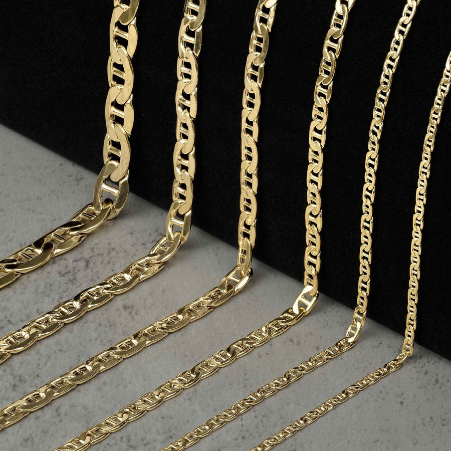 Six 10k gold mariner chain necklaces of varying widths displayed on a black background