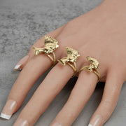 Mannequin hand with French tip nails wearing three 10k gold Nefertiti rings.