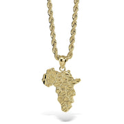 Gold pendant necklace featuring a textured, faceted map of Africa on a rope chain.