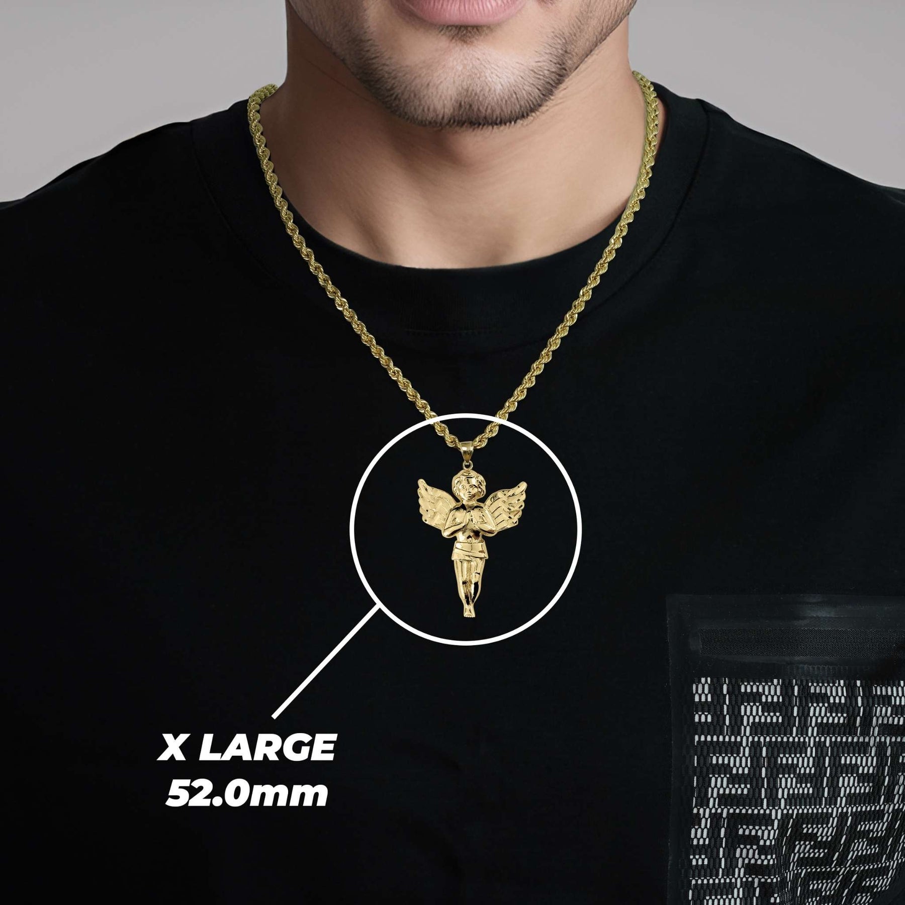 A man wearing an X Large gold angel pendant labeled X LARGE 52.0mm.