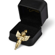Studio shot featuring the gold angel charm arranged neatly beside an open presentation box.