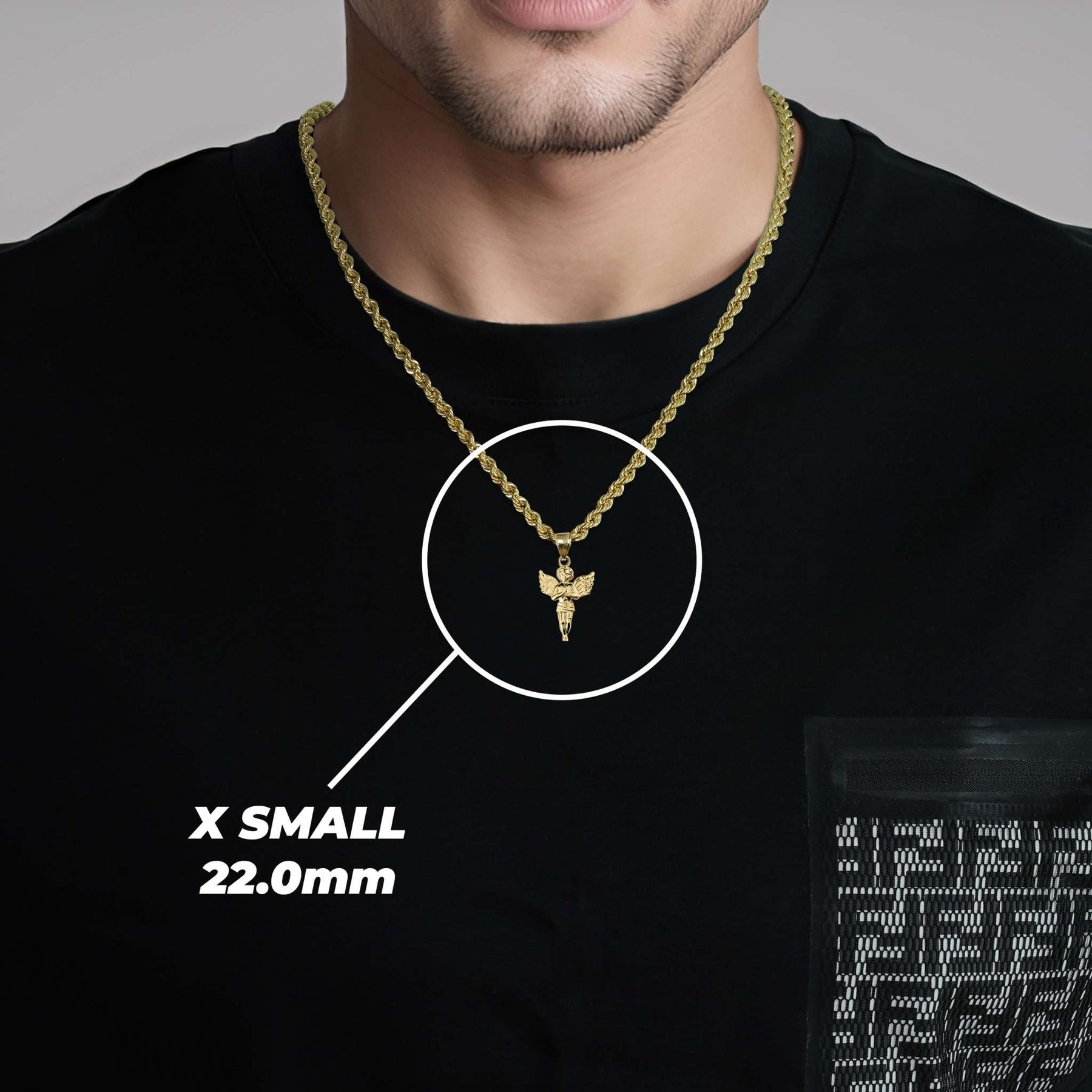 A man wearing an X Small gold angel pendant labeled X SMALL 22.0mm.